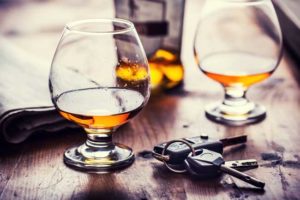 Couple of whisky glasses & car keys on a table